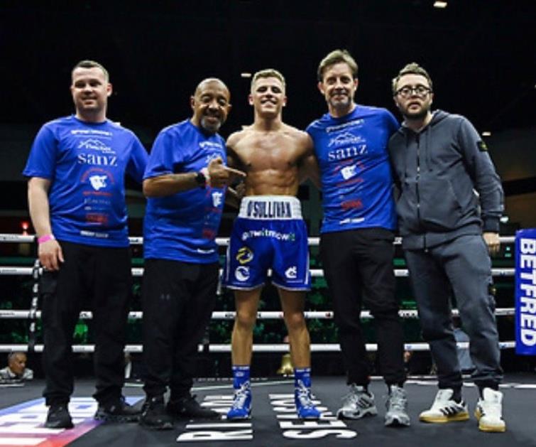  Mikey with his training team